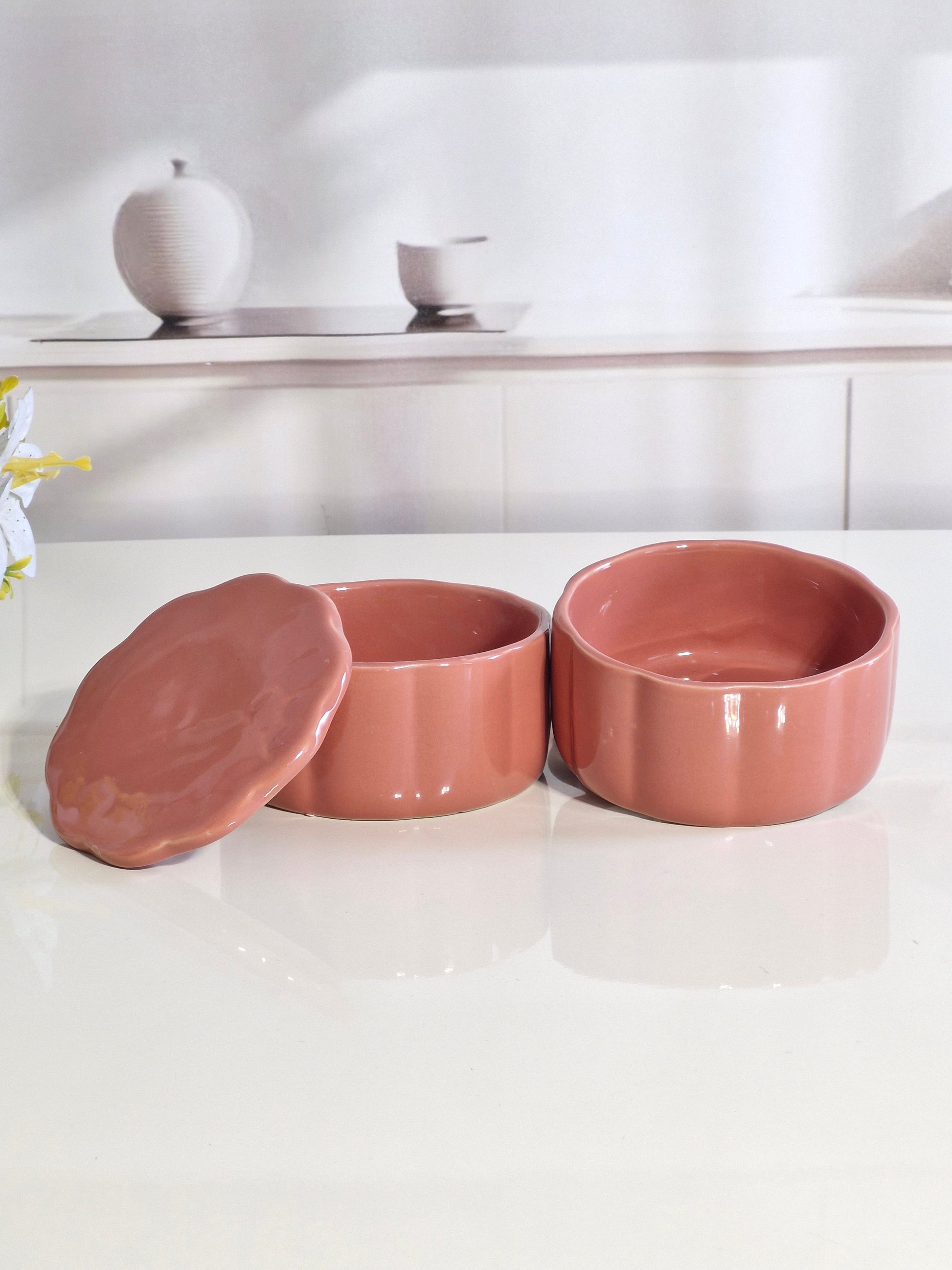 Two ceramic snack bowls open with lids beside them